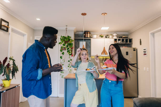 istock Friends dancing and eating at home 1885234318