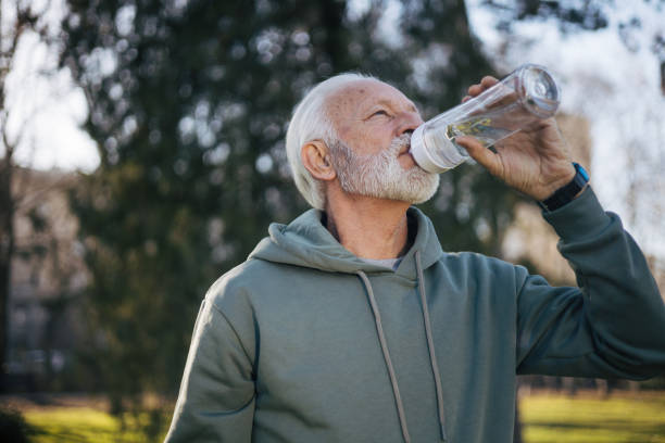 istock Senior man drinking water and resting after workout 1885234322
