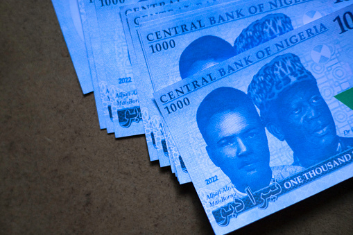 1000 Nigerian naira notes on wooden background with copy space.