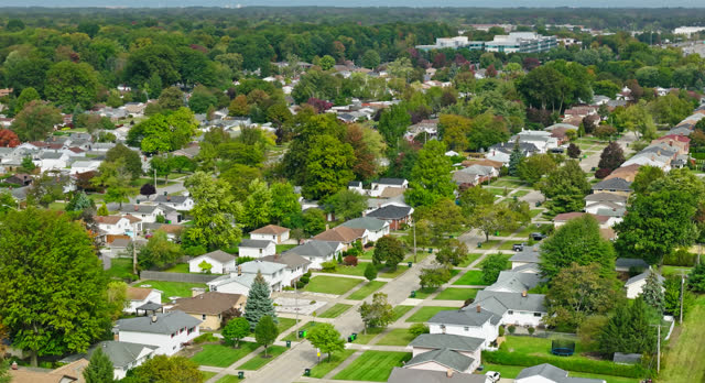 Aerial Shot of Suburban Neighborhood in Mayfield Heights, OH Tilting Up to Reveal Lake Erie