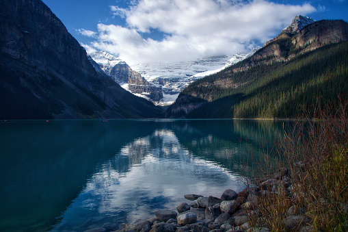 Wide shot of Canada's spectacular Lake Louise, with its mountain range reflected in the lake