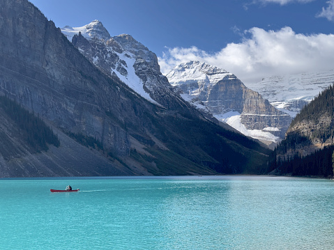 Medium shot of a single canoe against the spectacular mountains of Canada's Lake Louise