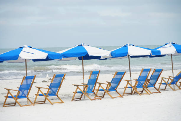 istock beach chair and umbrella in a row on the white sand beach 1885333868
