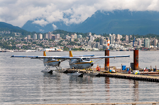 A vibrant image of the Port of Vancouver, bustling with activity and framed by the picturesque presence of sea planes. This scene captures the dynamic interface between urban development and natural beauty, emblematic of Vancouver's unique coastal charm.