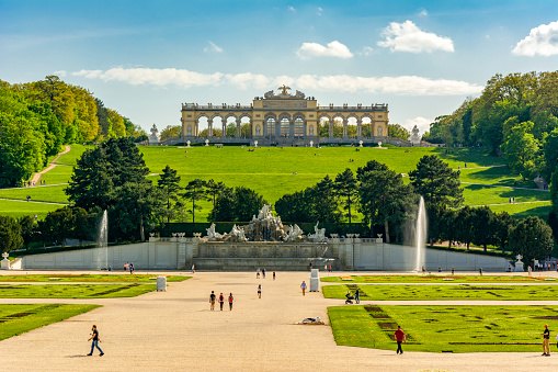 Vienna, Austria - May 28, 2015: Unidentified tourists by sightseeing of famous Upper Belvedere Palace. The Belvedere is a historic building complex in Vienna, Austria, consisting of two Baroque palaces the Upper (1717-1723), Lower Belvedere (1714-1716) and Gardens by Dominique Girard. Belvedere is one of the first public museums (1781) in the world