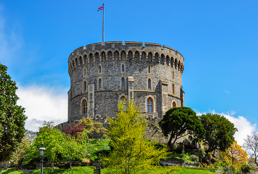 Windsor, UK - October 9, 2018: Windsor Castle building exterior and beautiful garden at sunny day, UK.