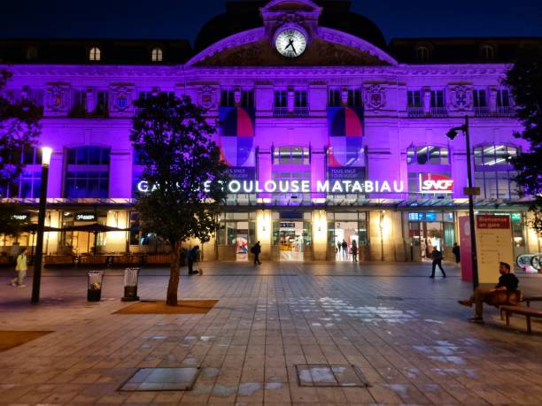 Toulouse-Matabiau is the main railway station in Toulouse, southern France. The current passenger building was built between 1903 and 1905. The image shows the station building with some people captured in early morning.