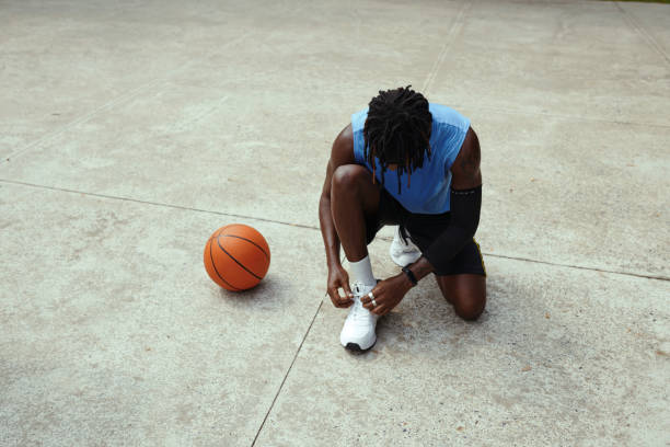 Streetball Player Tying Shoe Laces