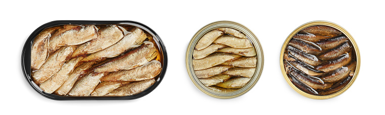 Tasty sprats in tin cans isolated on white, top view