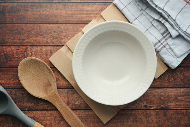 istock wooden cutlery , bowl and kitchen towel on a table 1885446421