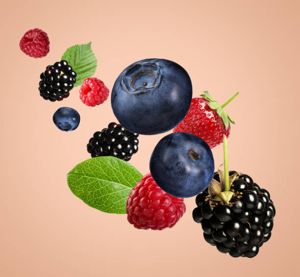istock Many different fresh berries falling on pink beige background 1885449005