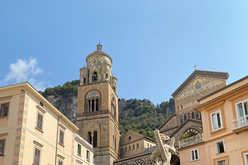 Facade of St. Andrew's Cathedral (Duomo di Almalfi), bell tower, buildings on the piazza, and statue of St. Andrew
