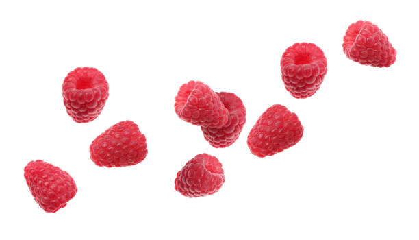 Fresh ripe raspberries falling on white background Fresh ripe raspberries falling on white background raspberry stock pictures, royalty-free photos & images