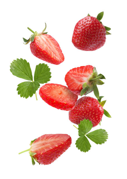 istock Fresh ripe strawberries and green leaves falling on white background 1885454274