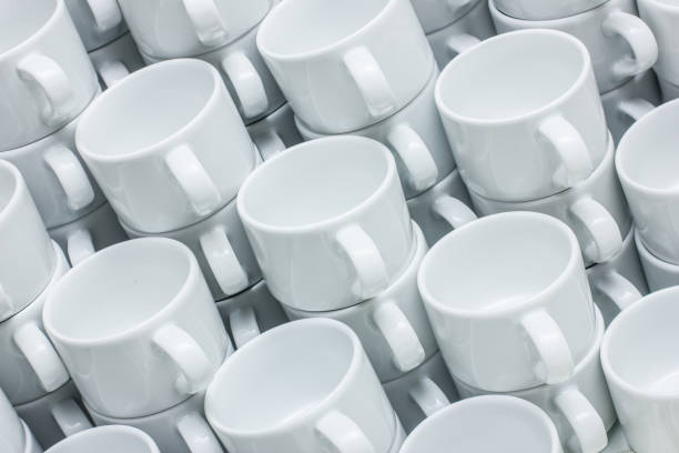 istock Coffee mugs stacked background. Ceramic mugs on white shelf. Coffee time background. Simple tea cups. Pile of mugs. 1885462726