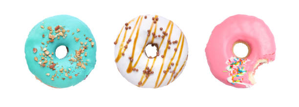 istock Whole and bitten tasty donuts with sprinkles isolated on white 1885465319