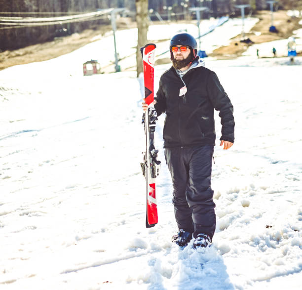 istock Middle age bearded man skiing on a ski slop in winter 1885476207