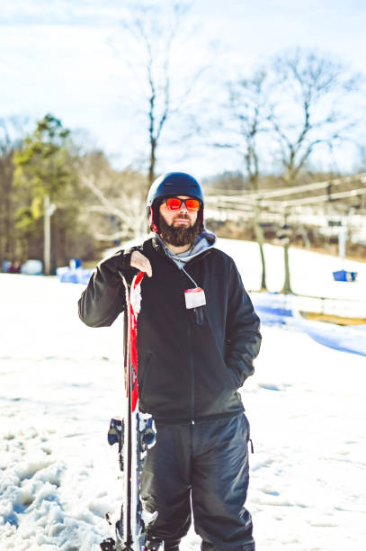 istock Middle age bearded man skiing on a ski slop in winter 1885479547