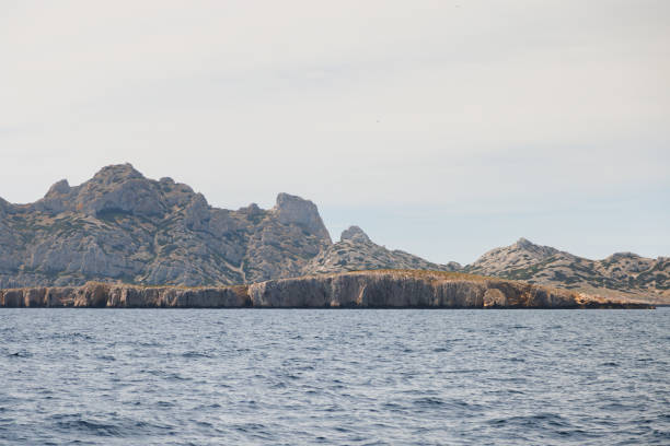 Rocky island with a high cliff, view from the sea