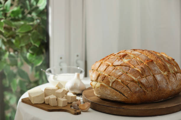 istock Freshly baked bread with tofu cheese and ingredients on table indoors 1885488264