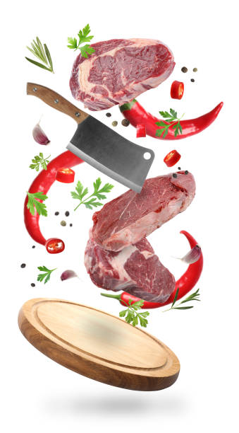 istock Beef meat, different spices, cleaver knife and board falling on white background 1885497055