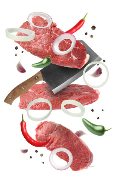 istock Beef meat, different spices and cleaver knife falling on white background 1885497560
