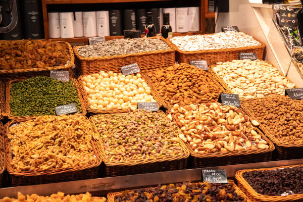 Barcelona, Barcelona - Spain - 09-02-2021: Various baskets filled with nuts, nut mixes, and almonds, labeled with price and variety, ready for sale and consumption.