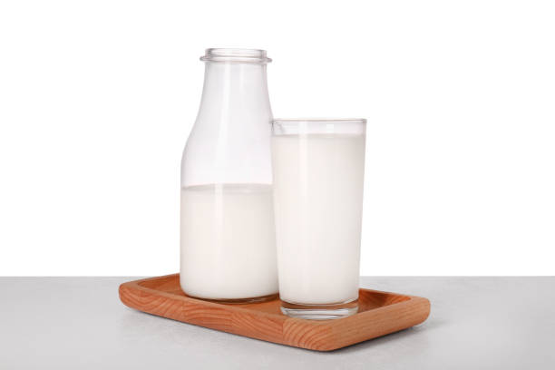 istock Glassware with tasty milk on light table against white background 1885516087