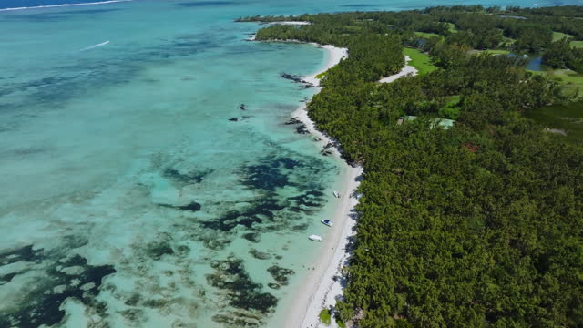 Aerial drone view of Ile Aux Cerfs, Flacq, Mauritius island, Indian Ocean. View of the white sanded beach in the tropical island. Summer holidays destination. Picturesque view of exotic landmark.