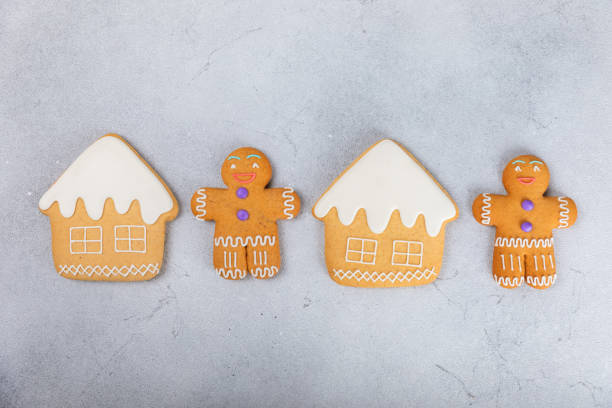 istock Merry Christmas! Cookies gingerbread house and gingerbread man with icing on a textured table background. Atmospheric Christmas sweets. Gingerbread. Christmas cookies. Place for text. Copy space. 1885565013
