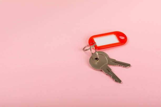 istock Plastic key ring in different colors with a place for a signature on a bright colored background. Bunch of keys with keychain. Mock-up keychain.Copy space.Concept for renting and selling real estate. 1885566055