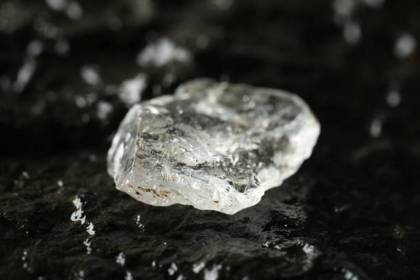 istock Shiny rough diamond on stone surface, closeup 1885588816