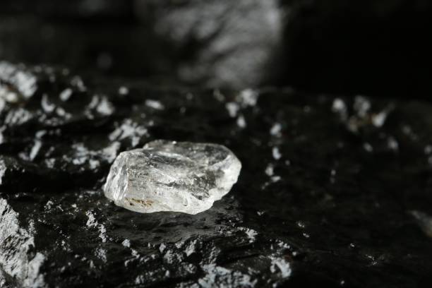 istock Shiny rough diamond on stone surface, closeup. Space for text 1885588818