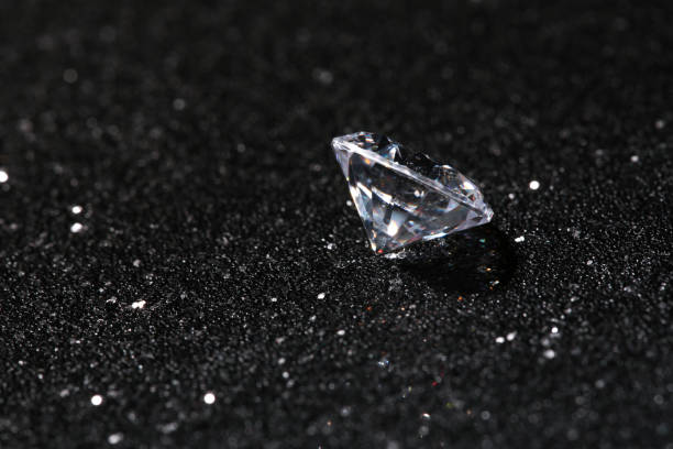 istock Beautiful dazzling diamond on dark shiny background 1885591984