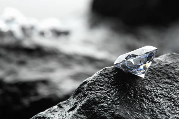 istock Beautiful shiny diamond on wet stone surface. Space for text 1885593035