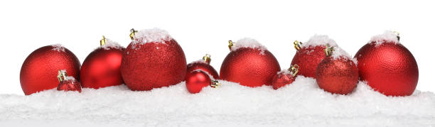 istock Beautiful red Christmas balls on snow against white background 1885652609