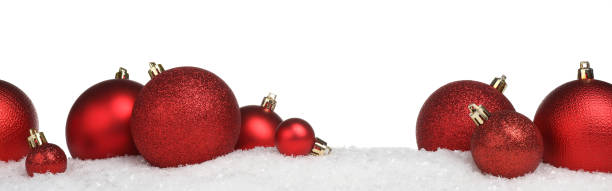 istock Beautiful red Christmas balls on snow against white background 1885653631
