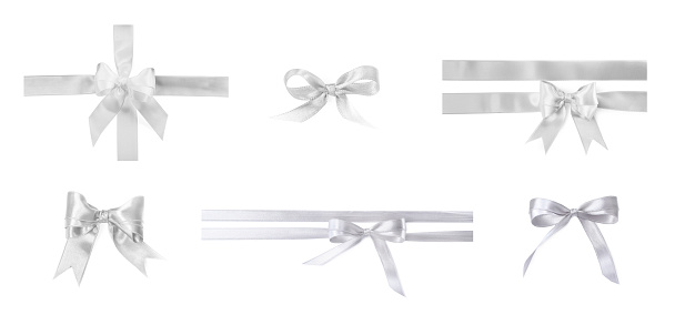 White satin ribbon and bows isolated on white, set