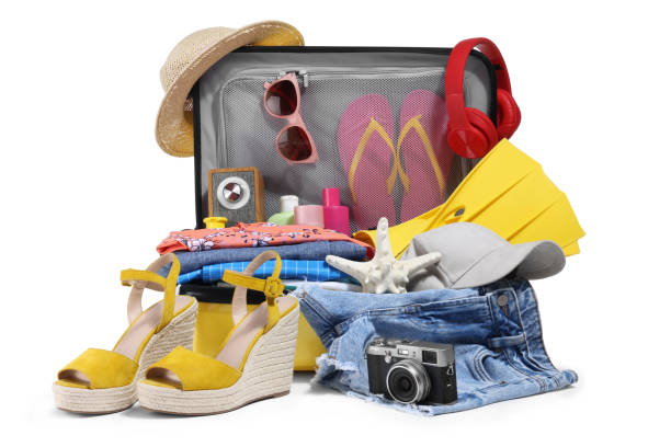 istock Open suitcase with clothes, beach accessories and shoes isolated on white. Summer vacation 1885665516