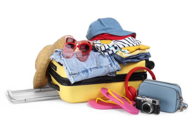 istock Open suitcase with clothes, beach accessories and shoes isolated on white. Summer vacation 1885666023
