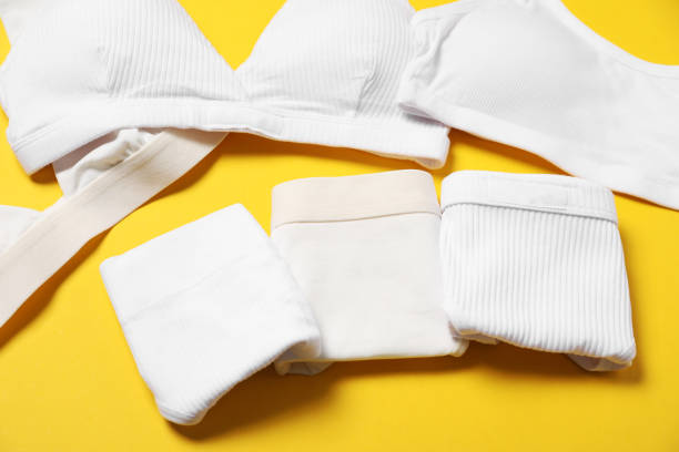 istock Stylish folded women's underwear on yellow background 1885672128