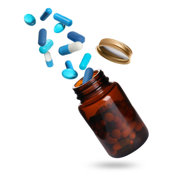 istock Many different colorful pills falling into bottle on white background 1885681316