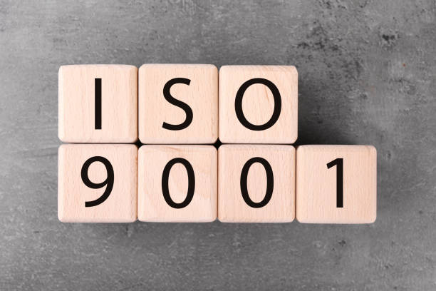 istock Wooden cubes with abbreviation ISO and number 9001 on grey textured table, flat lay 1885701825