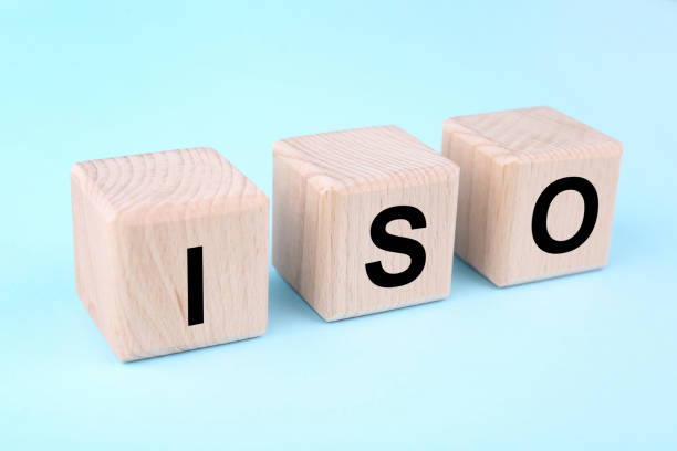 istock International Organization for Standardization. Wooden cubes with abbreviation ISO on light blue background, closeup 1885702347