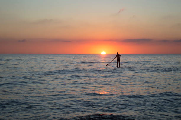 istock Paddle boarding with sunset at the sea in Solanas beach, Punta del Este 1885708065