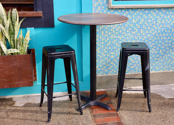 istock Bistro table with black metal barstools 1885712232