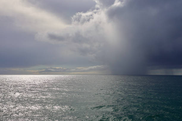 istock Sunshine through stormy clouds out at sea 1885713295