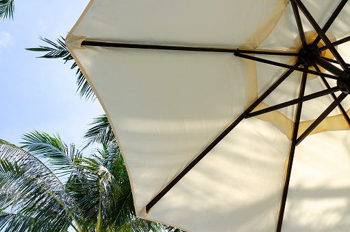 Parasols on a beach in Thailand. This picture highlights the relaxed and festive atmosphere of Thai beaches, a visual treat of tropical leisure.