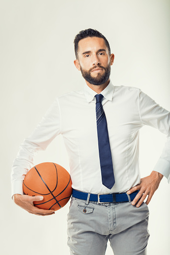 corporate strategist in business attire promotes sports as a model for business excellence