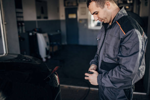 istock Man charging power to electric vehicle 1885731982